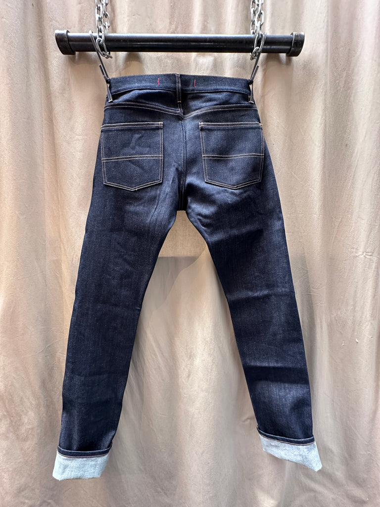 Brooklyn Denim Co Men's Slim 11 oz. Raw Stretch Jean merges modern fit with heritage craftsmanship, delivering a streamlined silhouette that doesn't sacrifice comfort. Cut from premium 11 oz. raw stretch denim fabric, this pair offers the perfect balance of structure and flexibility—ideal for those seeking versatile mens stretch jeans that move with you. Designed in Brooklyn and constructed with meticulous attention to detail, these stretch jeans are built to break in beautifully. 