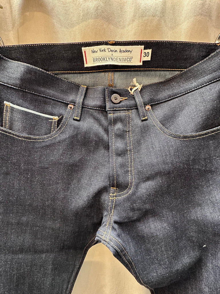 Brooklyn Denim Co Men's Slim 11 oz. Raw Stretch Jean merges modern fit with heritage craftsmanship, delivering a streamlined silhouette that doesn't sacrifice comfort. Cut from premium 11 oz. raw stretch denim fabric, this pair offers the perfect balance of structure and flexibility—ideal for those seeking versatile mens stretch jeans that move with you. Designed in Brooklyn and constructed with meticulous attention to detail, these stretch jeans are built to break in beautifully. 