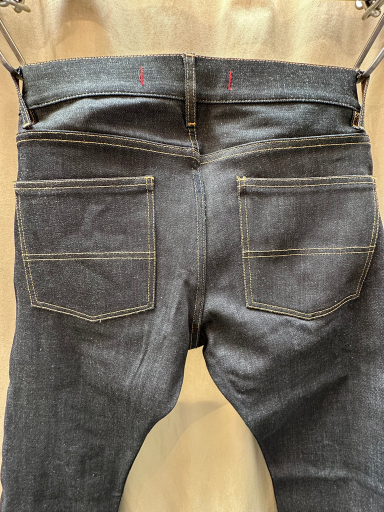 Brooklyn Denim Co Men's Slim 11 oz. Raw Stretch Jean merges modern fit with heritage craftsmanship, delivering a streamlined silhouette that doesn't sacrifice comfort. Cut from premium 11 oz. raw stretch denim fabric, this pair offers the perfect balance of structure and flexibility—ideal for those seeking versatile mens stretch jeans that move with you. Designed in Brooklyn and constructed with meticulous attention to detail, these stretch jeans are built to break in beautifully. 