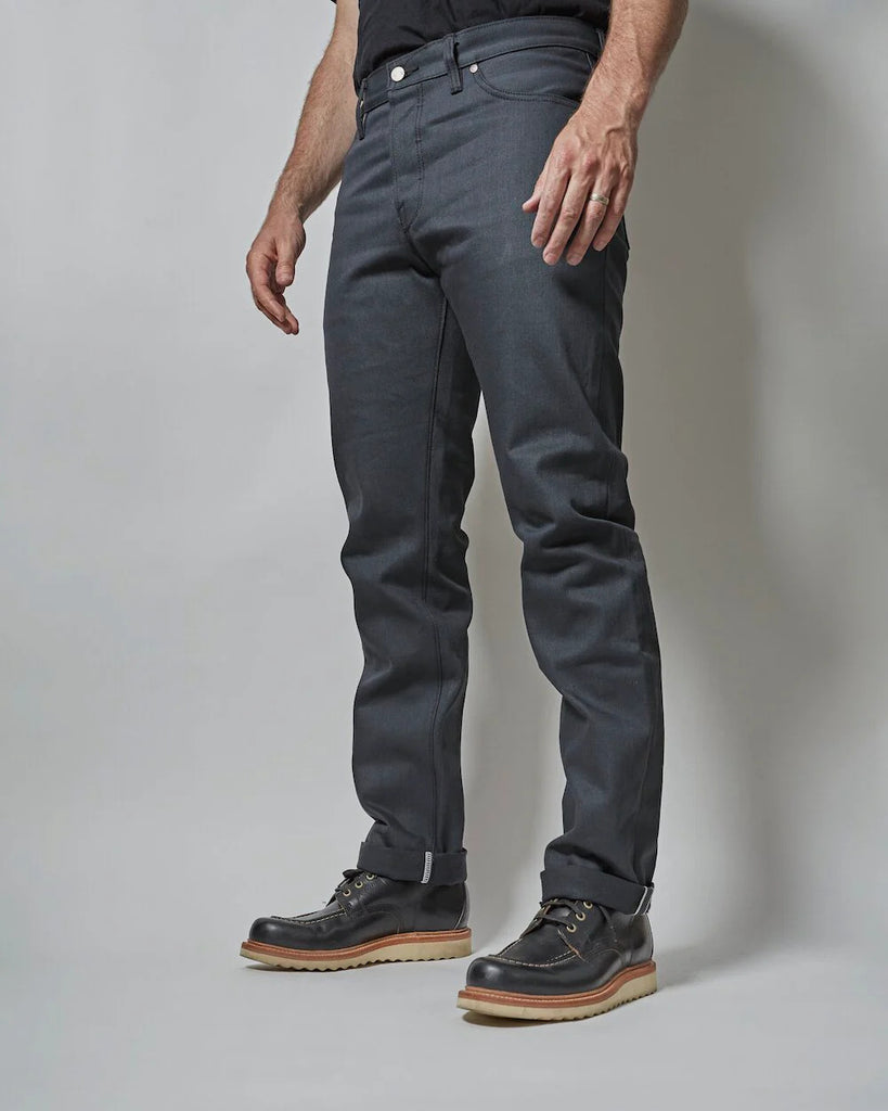 Gunmetal comes in a solid 14oz fabric with slight slub and is made with a charcoal warp and black weft that gives the fabric its distinct dark grey face. It will fade and lighten with wear, though the black fill yarns help to keep the color darker longer. Grey denim is particularly versatile and is often a great way to add a staple and diversify your wardrobe at the same time. A pair of Gunmetal denim slots into any denim lover's well curated closet.
- 14oz selvedge denim
- 100% cotton
-Dark grey warp