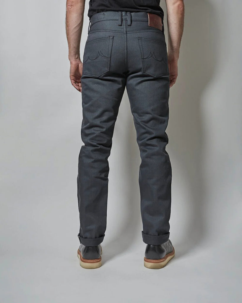 Gunmetal comes in a solid 14oz fabric with slight slub and is made with a charcoal warp and black weft that gives the fabric its distinct dark grey face. It will fade and lighten with wear, though the black fill yarns help to keep the color darker longer. Grey denim is particularly versatile and is often a great way to add a staple and diversify your wardrobe at the same time. A pair of Gunmetal denim slots into any denim lover's well curated closet.
- 14oz selvedge denim
- 100% cotton
-Dark grey warp