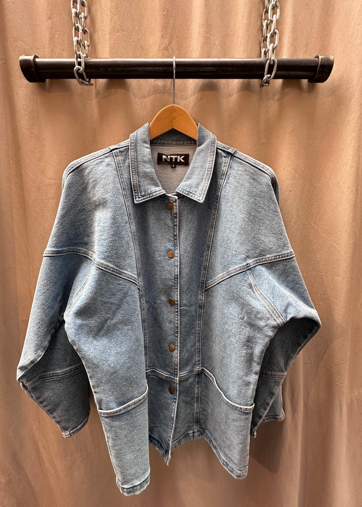 The TT Studios LINDA UNION SQ Relaxed Fit Denim Jacket blends everyday ease with timeless denim craftsmanship, offering a versatile layer for effortless styling. Designed with a relaxed fit and classic button-front closure, this jacket is crafted from premium denim fabric with a touch of stretch for all-day comfort. Featuring two functional front pockets, it delivers both style and utility—making it a wardrobe staple that pairs seamlessly with everything from dresses to denim-on-denim looks.
