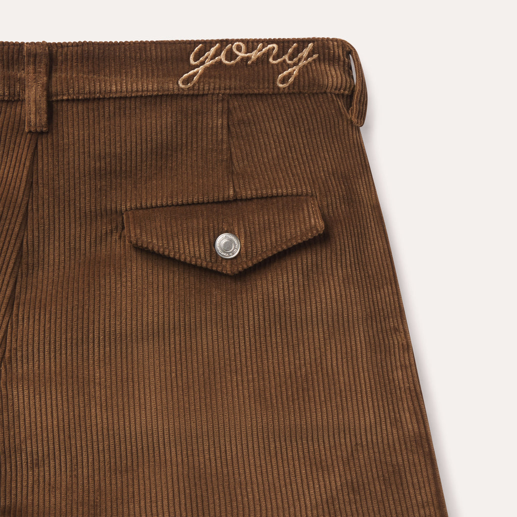 Corduroy wide leg pants
Made in Los Angeles
Single pleat
Pin tuck
Embroidered waistband featuring "yony" script logo
Brass tack button closure on waistband
Back triangular welt pockets with brass tack button closure
Fabric: 100% cotton | Made in Italy
Pocket Lining: 100% cotton | Made in USA
Zipper: YKK  | Made in USA

Dry clean only