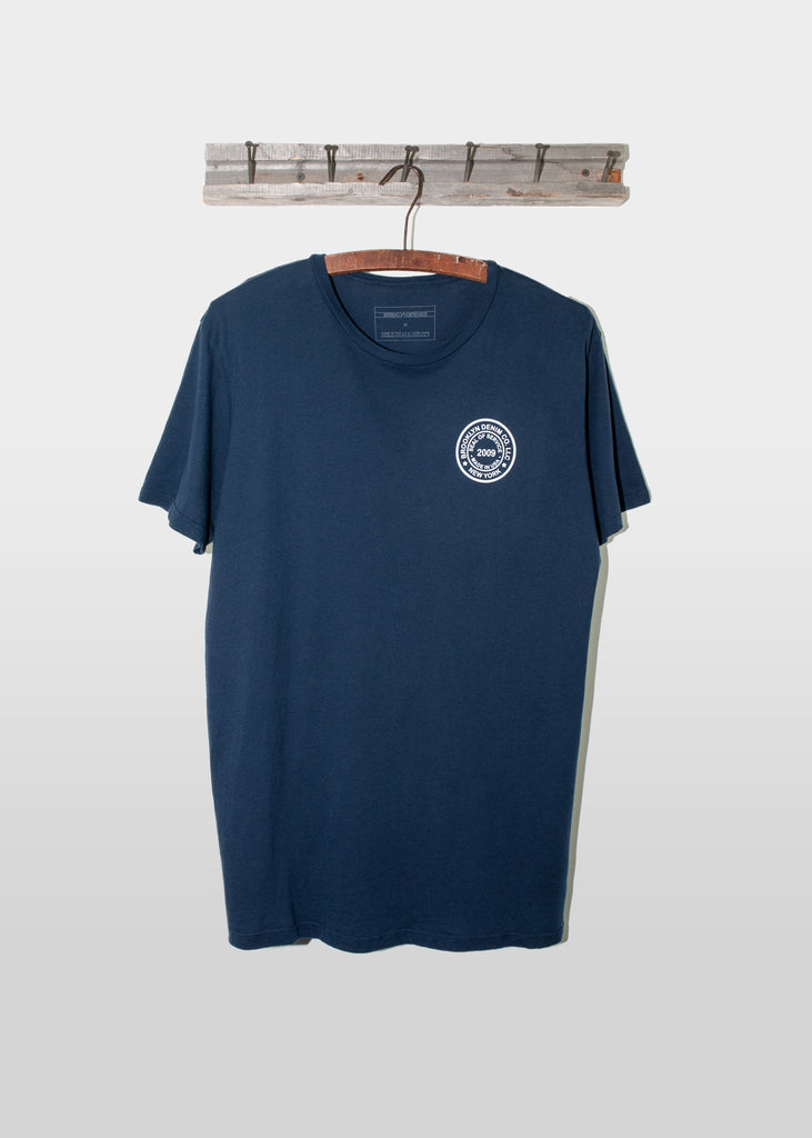 Brooklyn Denim Co. Graphic Tee. This Brooklyn Denim Co. screen printed logo seal tee is a super soft short sleeve tee with a crew neckline.

Details:

*100% organic cotton

*Pre-Shrunk

*No tag

*Made in USA