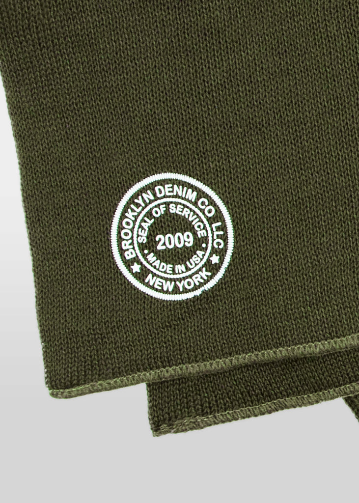 Made from 100% wool, this Brooklyn Denim Co. knit scarf has an updated vintage military deadstock vibe. This scarf features the Brooklyn Denim Co. seal logo, screen printed in white. Keep warm this winter in Brooklyn Denim Co merch! Available in black and olive.

100% wool

Screen printed seal logo
One size fits all