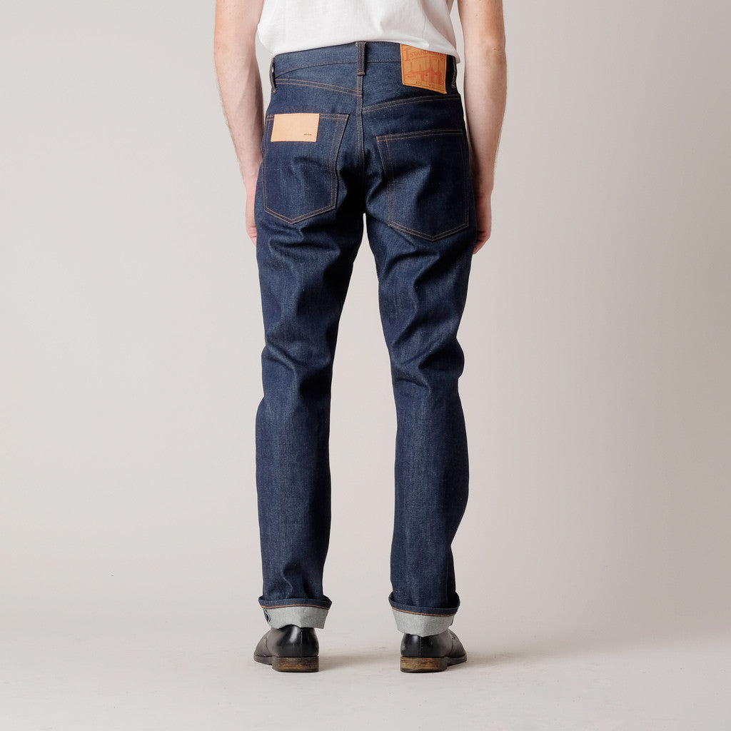 These First Standard Co. jeans are almost the "classic jean", with the exception of asymmetrical front pockets, back yoke and back pockets, feature a zip fly single button button closure with the 5 pocket style and oversized front and back pockets and First Standard's signature cowhide tooling leather patch.

Details:

*100% Cone Mills White Oak Cotton



*13.5 oz. Raw Selvage Denim

*Asymmetrical front pockets, back yoke and back pockets

*Straight Leg

*Metal Button Closure
